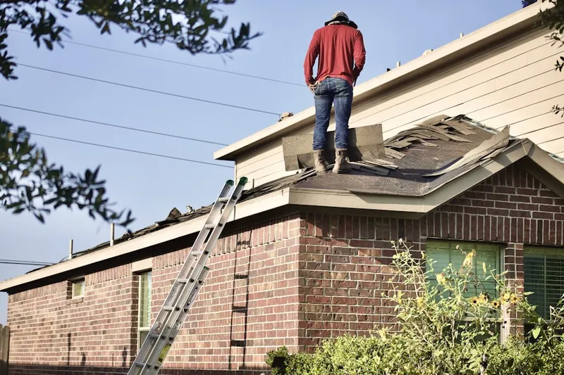 Professional roofer working on a residential roof in Rushland